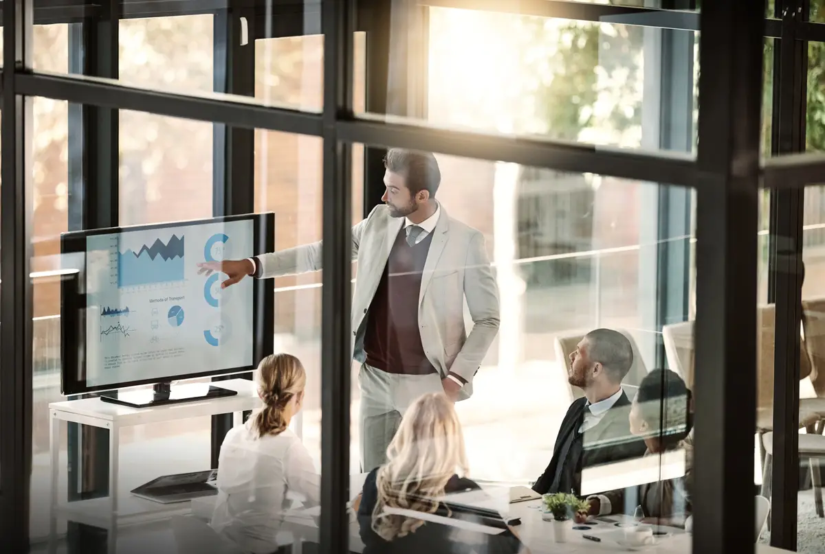 Corporate meeting window and people presentation company statistics and data analytics charts or graphs Speaker business manager or man and staff with infographics revenue or profit on screen