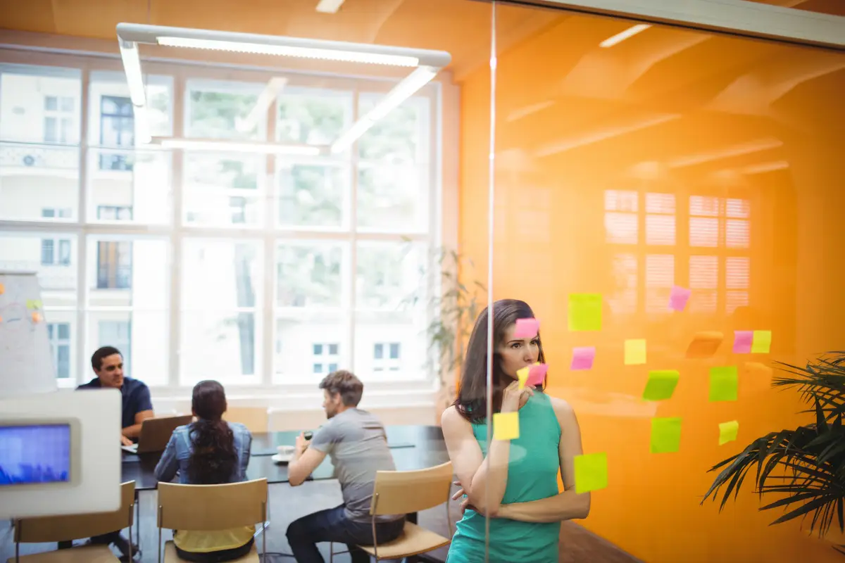 Female executive reading sticky notes
